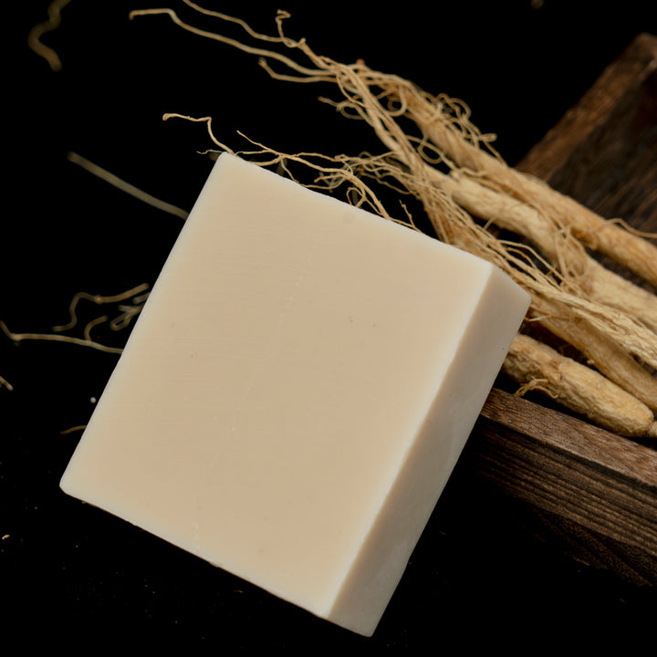 Close-up of handmade ginseng soap lathering in hand